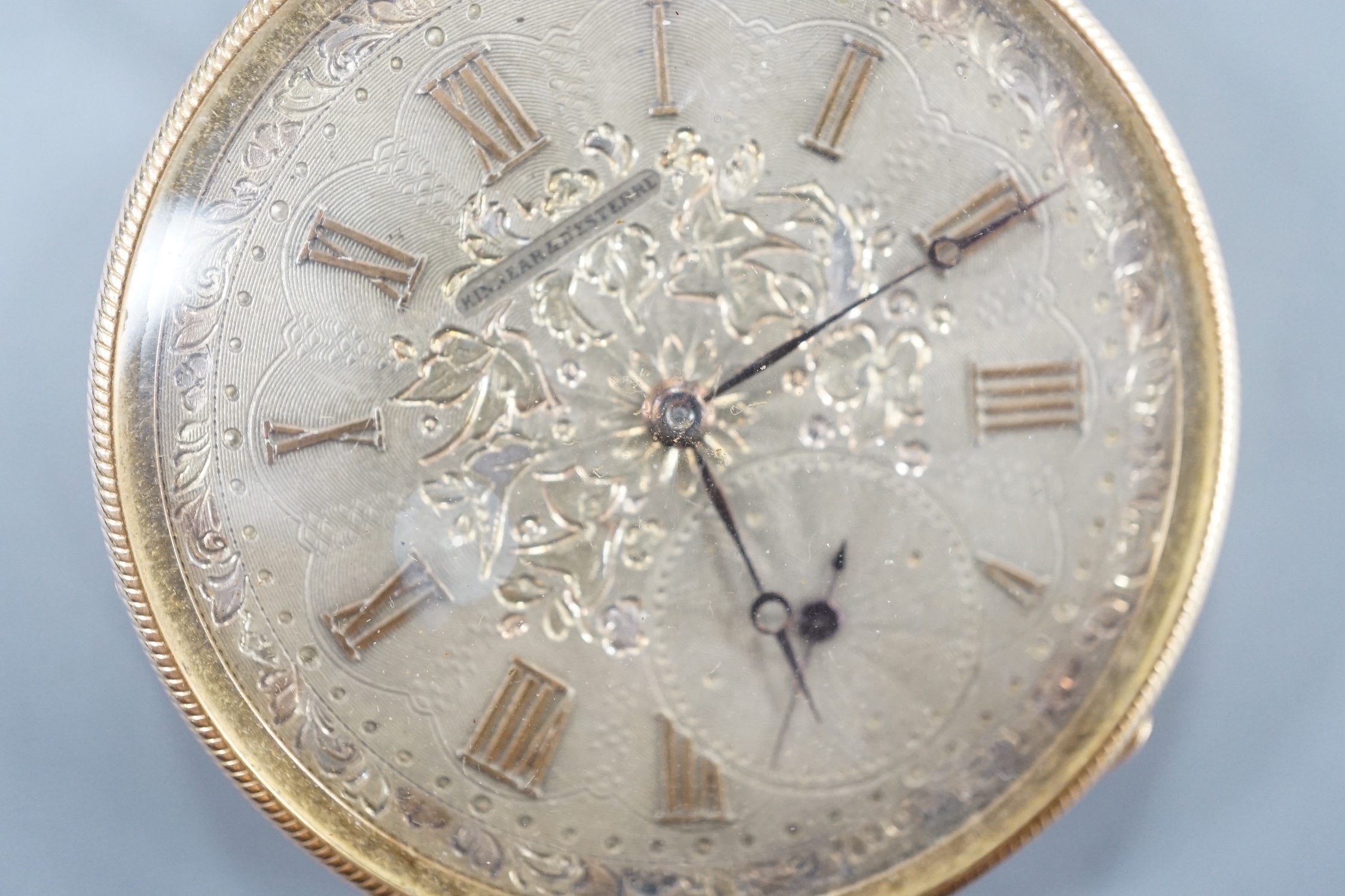 An early 20th century Swiss yellow metal open faced keyless dress pocket watch, retailed by Kinnear & D'Esterre, case diameter 44mm, gross 52 grams.